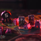 Board game pieces with characters and numbers on a dark surface