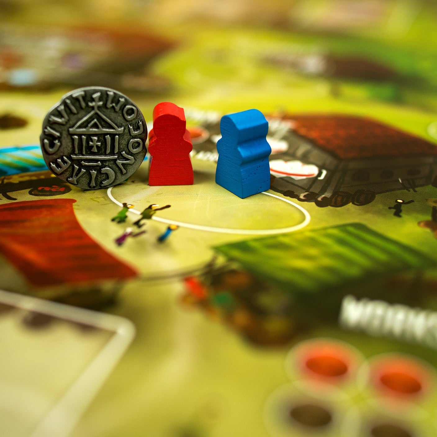 Board game pieces on a board with colorful tokens and game elements.