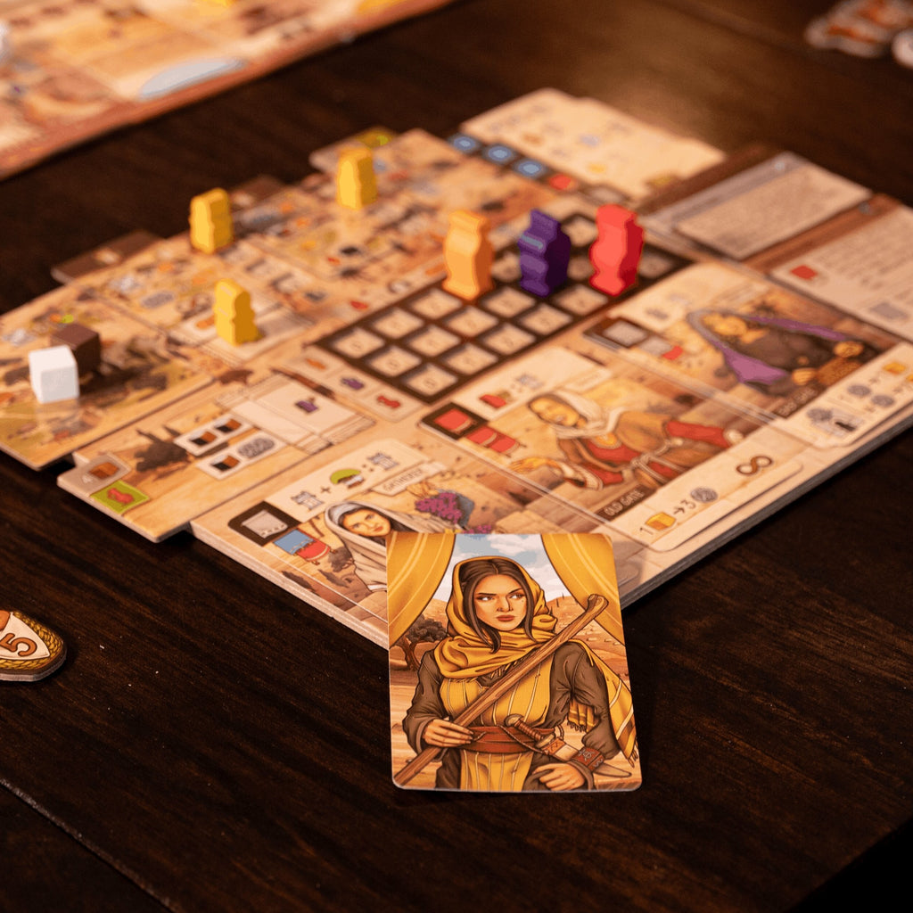 Board game in progress with cards and pieces on a wooden table