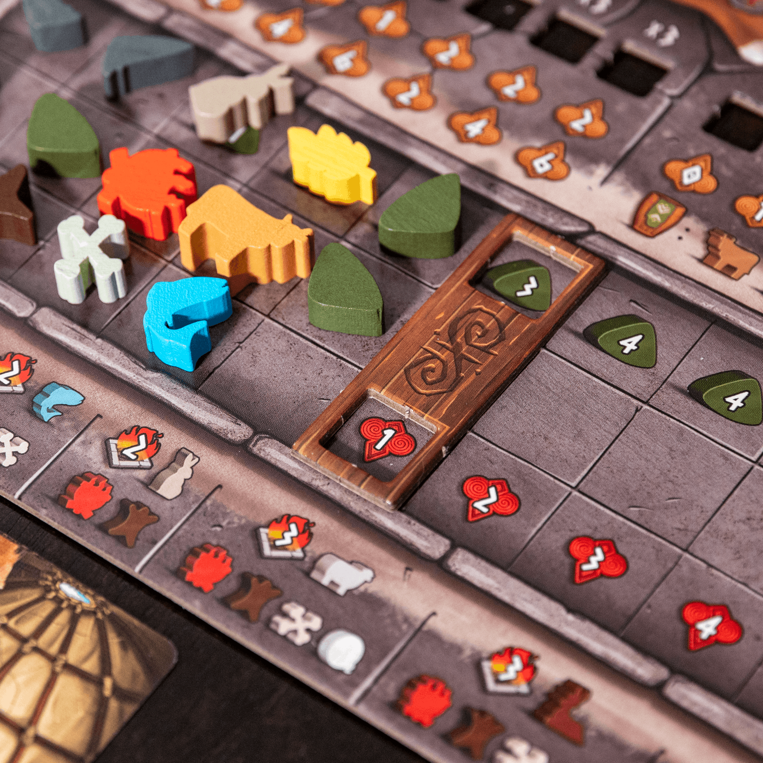 Close-up of a board game with various pieces and numbers on a wooden surface.